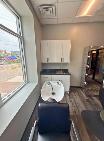 Fully equipped salon suite with hair stylist chair and mirror at Broadway Royal Oak, MI