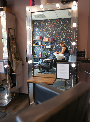 Fully equipped salon suite with hair stylist chair and mirror at Broadway Royal Oak, MI