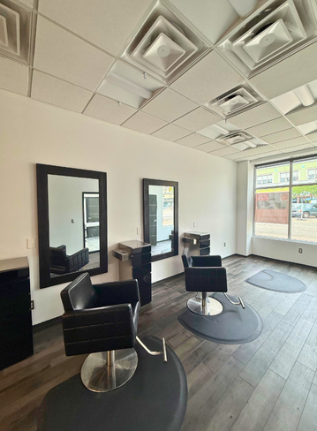 Fully equipped salon suite with hair stylist chair and mirror at Broadway Royal Oak, MI