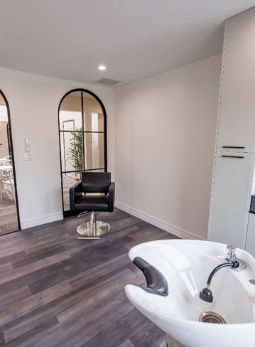 Fully equipped salon suite with hair stylist chair and mirror at Broadway La Jolla