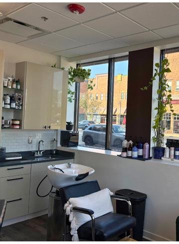 Fully equipped salon suite with hair stylist chair and mirror at Broadway Novi, MI