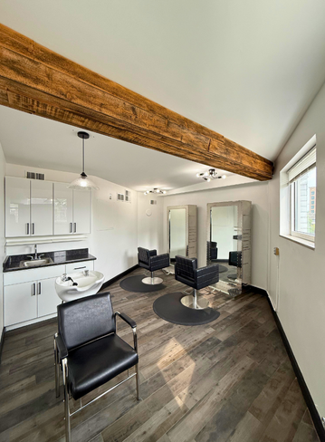 Fully equipped salon suite with hair stylist chair and mirror at Broadway Royal Oak, MI