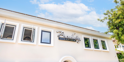 Exterior of a building with multiple windows and a sign reading "Broadway."