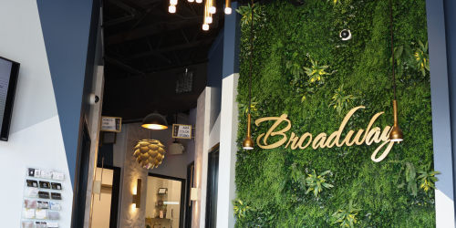 Interior space featuring a green wall and the word "Broadway" in cursive