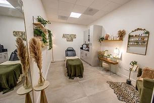 Aesthetic treatment room with a chair, table, and decorative plants