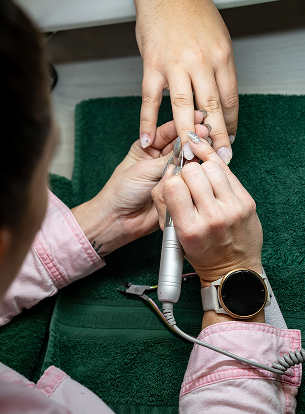 A person holds a nail file while working on another person's hand