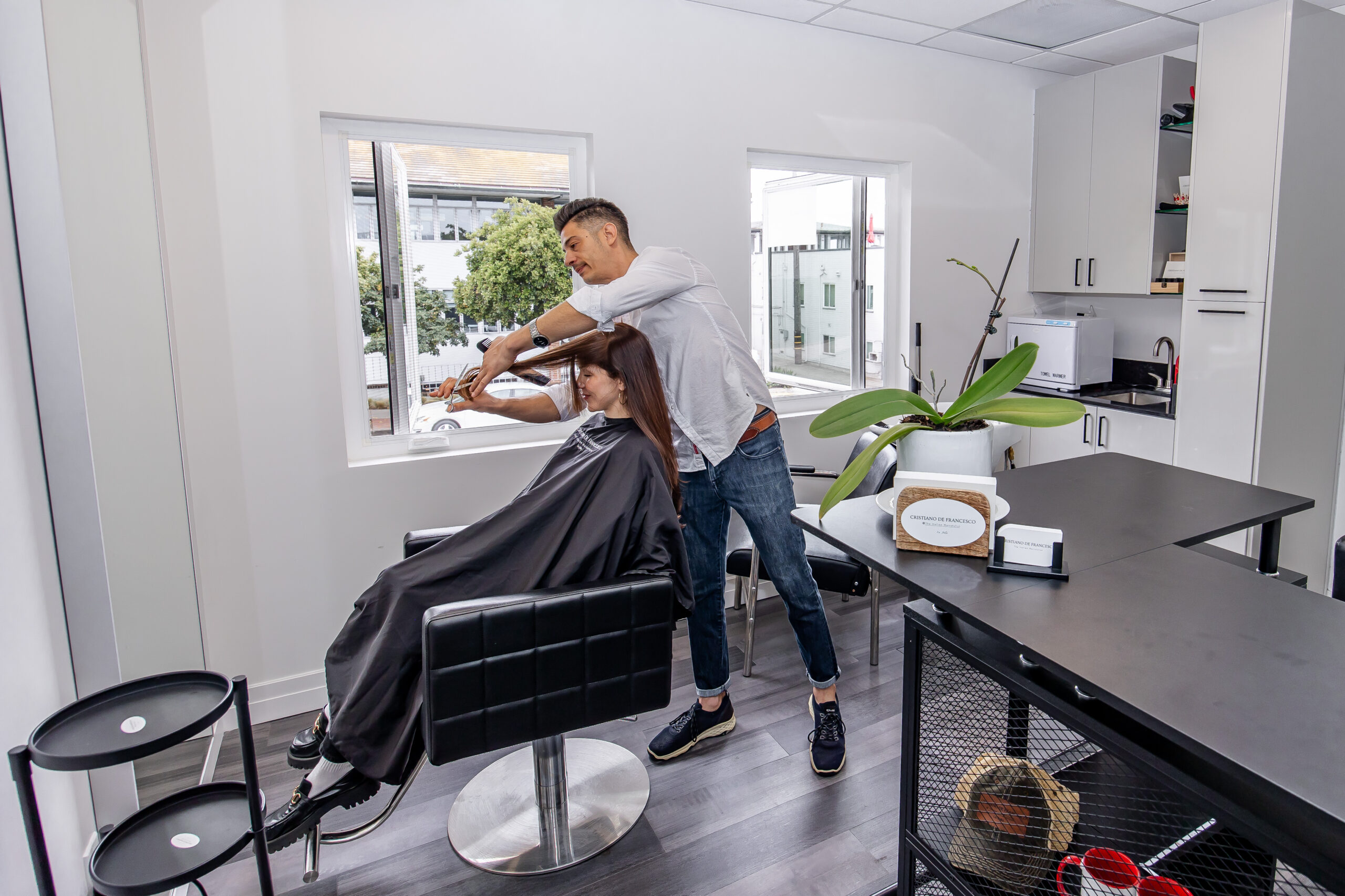 Fully equipped salon suite with hair stylist chair and mirror at Broadway La Jolla